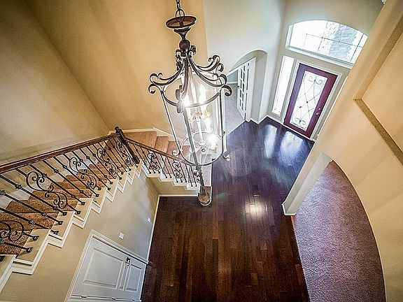 Grandeur nicely describes the Foyer with its two-story ceiling, soft arches and natural light.
