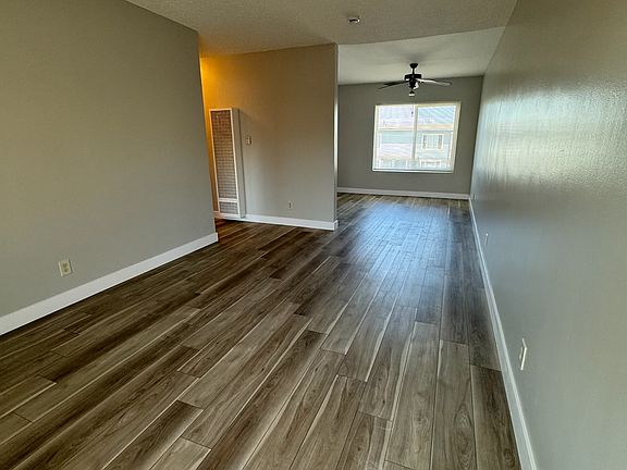 Living room with natural lighting, new flooring and fresh paint.