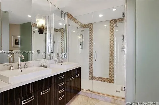 Luxurious master bathroom with double sinks and dual shower heads.