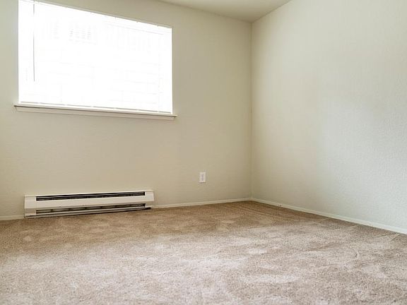 Apartment homes at Sunset Gardens include a full sized washer and dryer, ceiling fan, walk-in closet, living room with wood burning tiled fireplace and bay window. Exact features, flooring, colors, and dimensions vary from one apartment to another and may