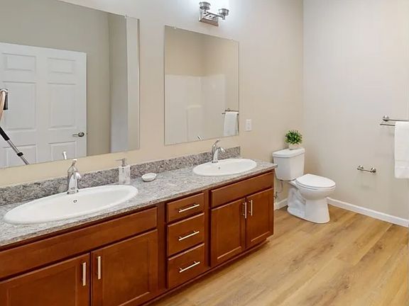 Large bathrooms with stone counters.