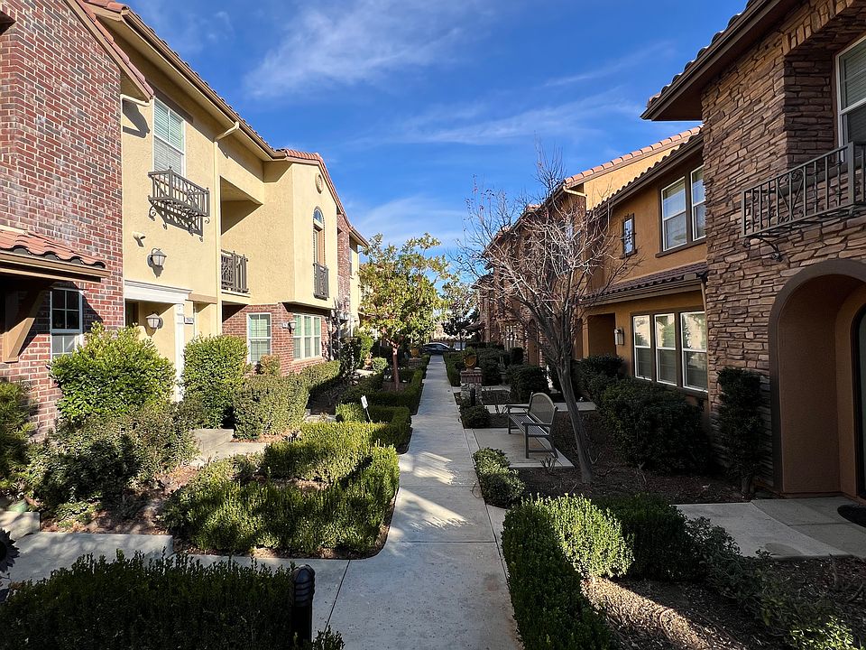 Delightful front walkway with benches and lighting