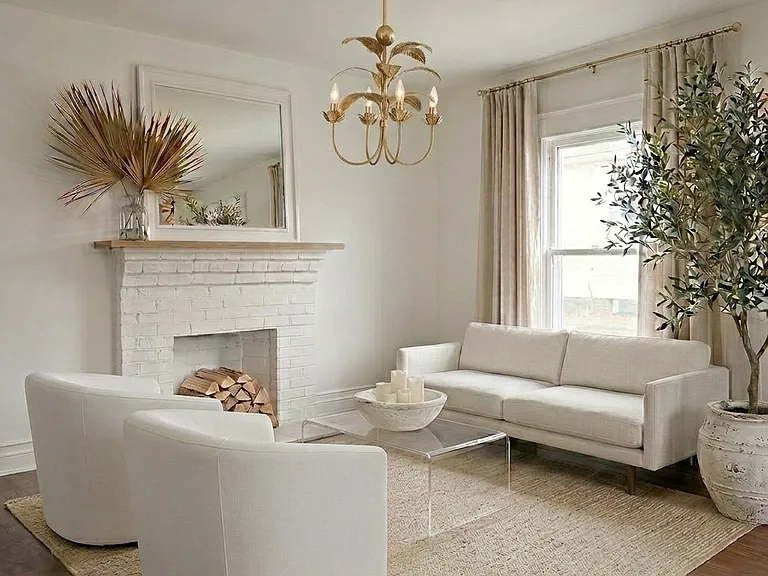 Living room with nine foot ceilings, a fireplace, dreamy solid walnut hardwood floors, a pottery barn chandelier and natural light.