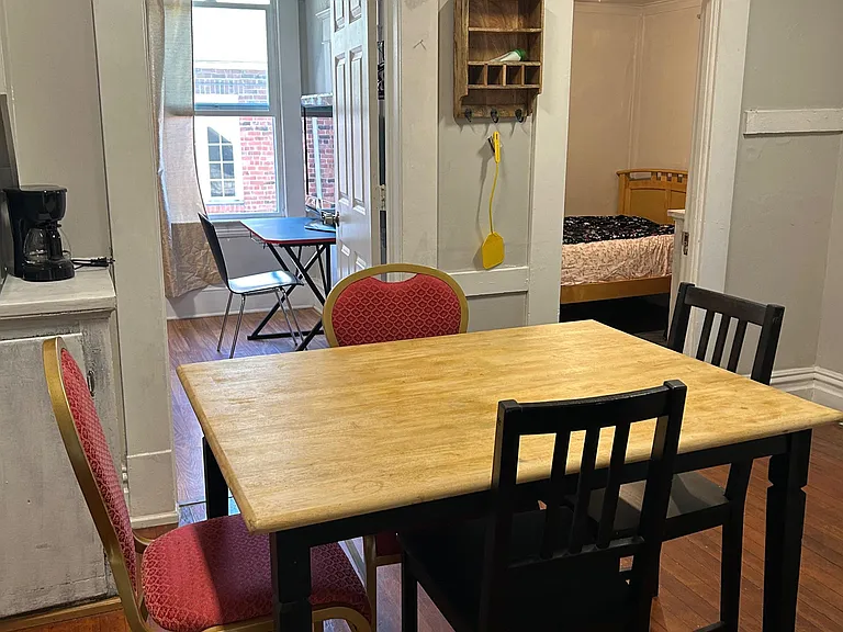 Dining area with a full-size table, hardwood floors, and convenient access to adjacent rooms for easy everyday meals.