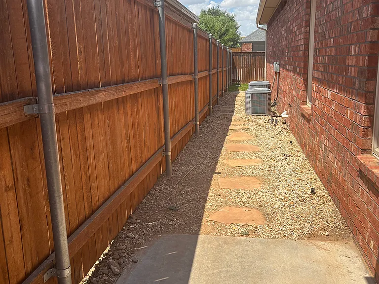 Side fenced yard grass area in back