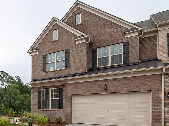 This End Unit, Montana, Exterior 3 features brick, side covered entry and 2 car garage