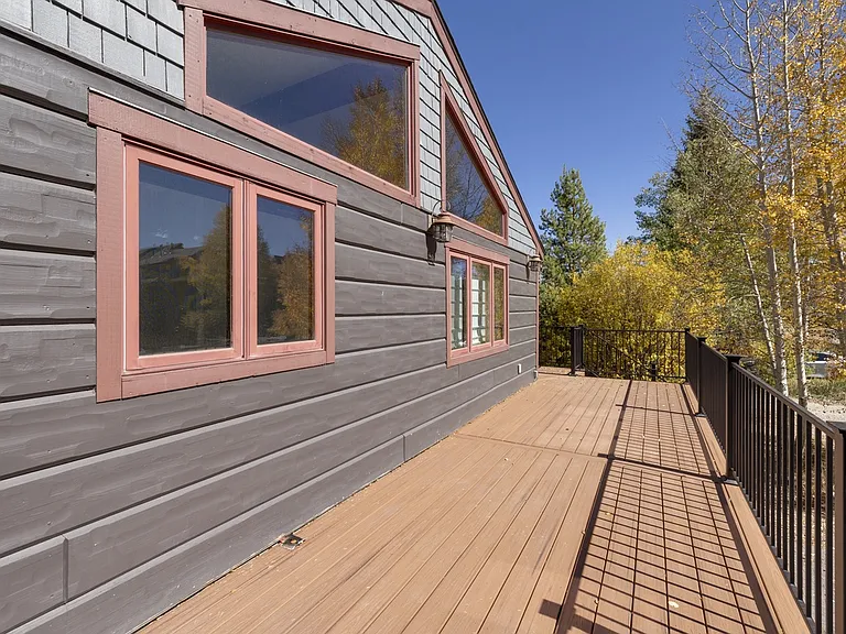 large new deck with patio table and chairs.