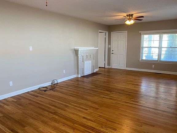 Large great room/Dining room open concept. Look at that adorable fireplace/mantle. Bathed in natural light. 2 inch blinds on every window.