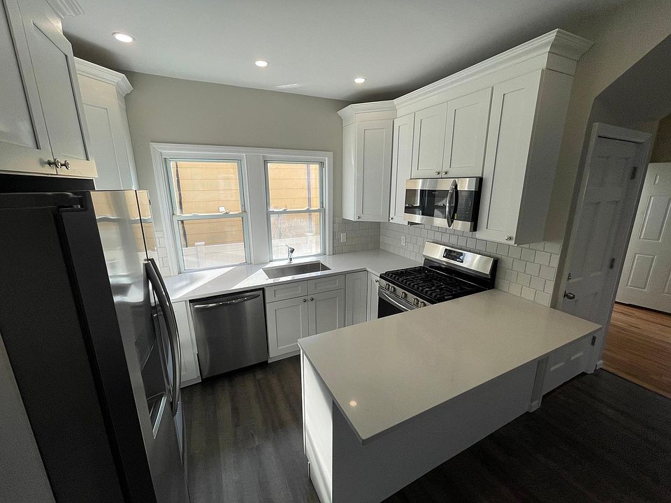 Kitchen with bar microwave vents outside.