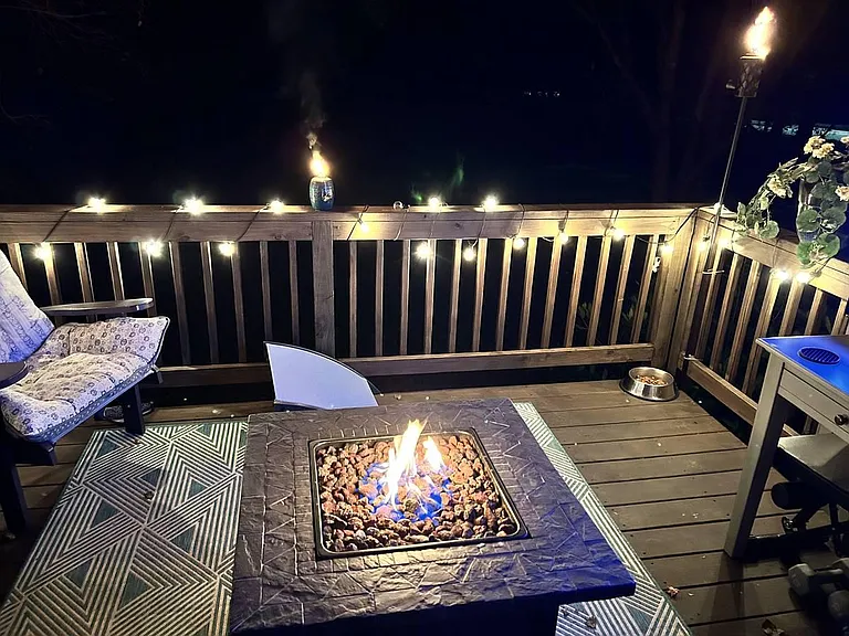 Upper deck has firepit, couch and 55 inch TV.