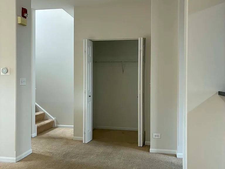 closet by the living room & stairs to 2nd floor