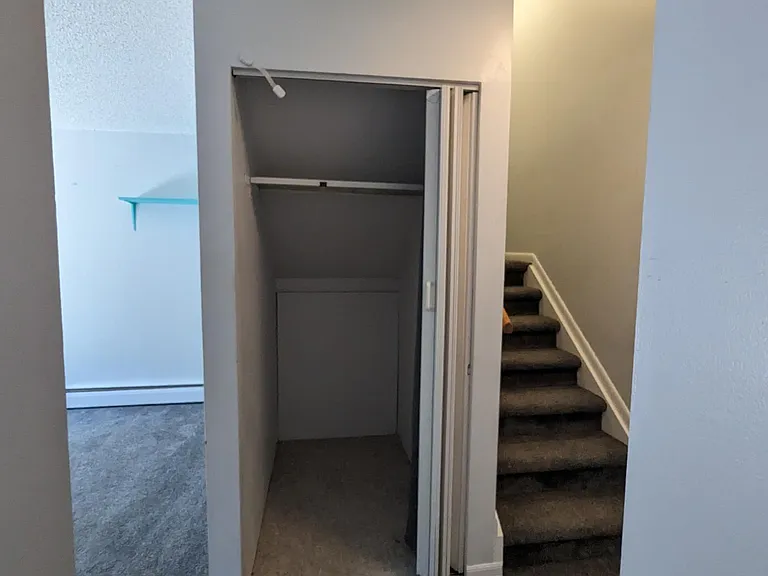 Large coat closet is conveniently located across from powder room