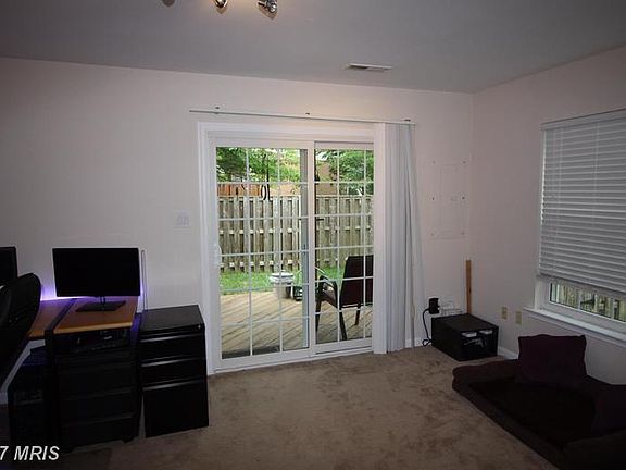 Rec Room leading to Fenced Yard with Patio