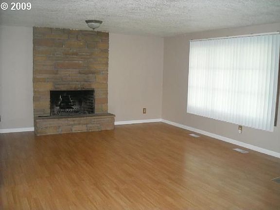 Large Open living room with laminate hardwoods and fireplace