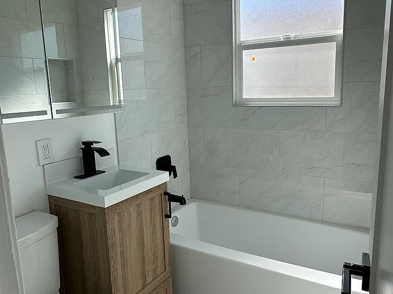 Fully Remodeled Bathroom. Storage mirror has outlets for toothbrushes and shavers.