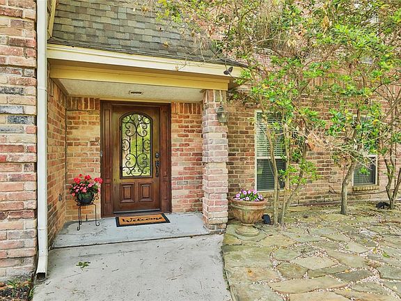 Welcome to 5406 Cobble Ln! Notice the pretty front door with iron trim.