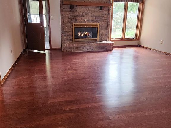 Great Room with Gas Log F.P. and adjoining glassed in Porch