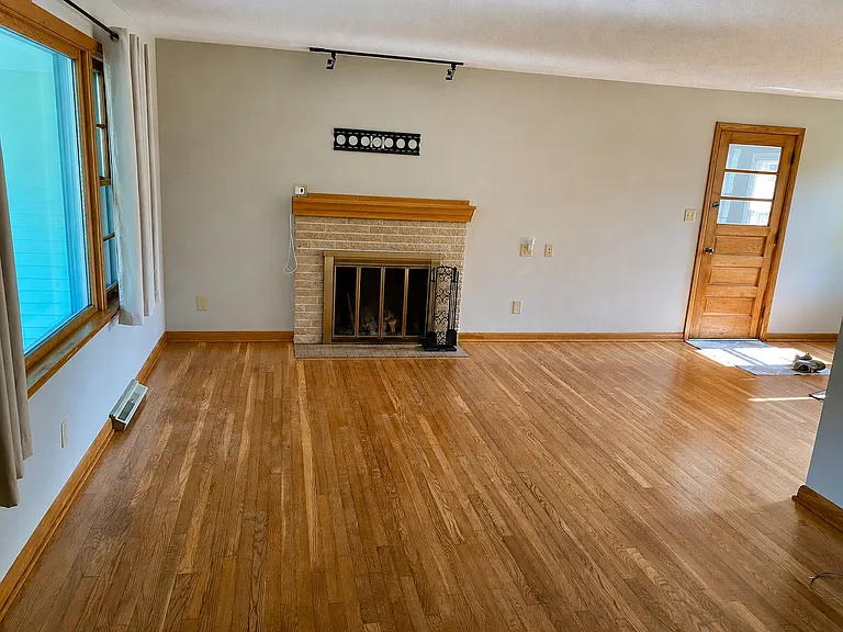 Family room with wood burning fireplace.