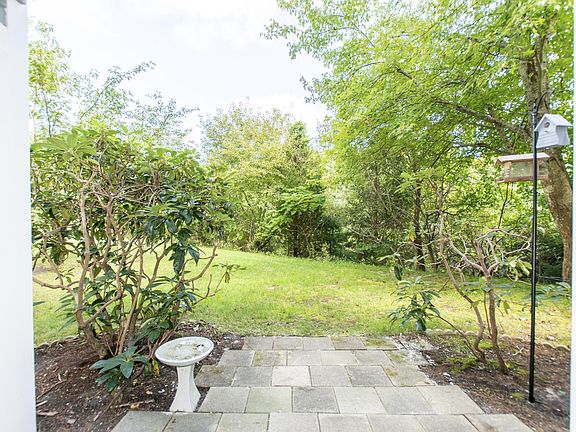 Ground floor patio faces the wooded back yard
