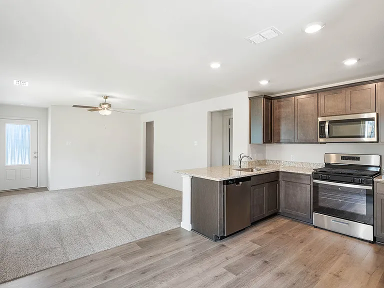 The kitchen has sprawling granite countertops.