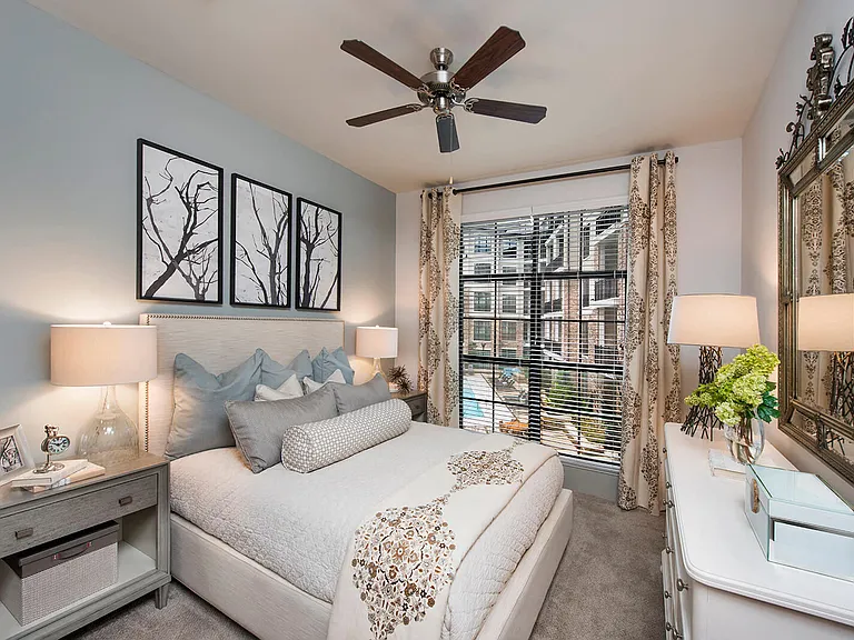 Plush carpeting, ceiling fans and expansive windows in bedrooms