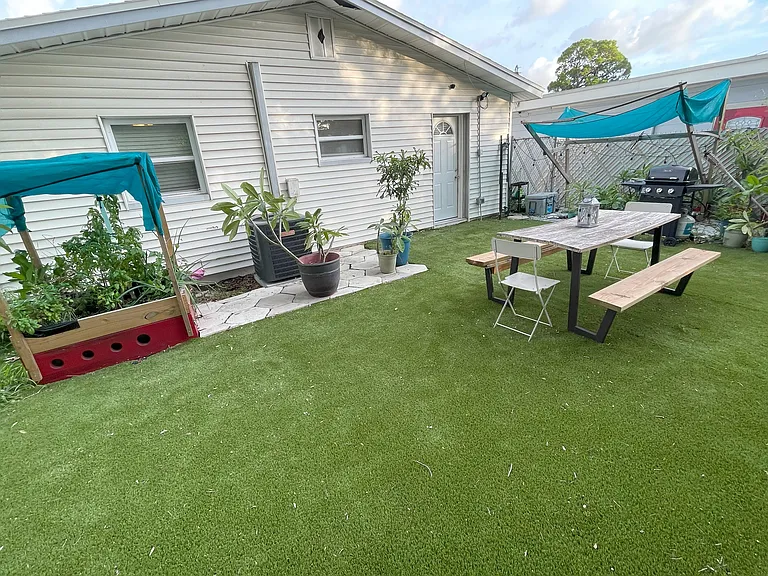 back yard with picnic table, gas grille and herb garden (we can remove if not wanted)
