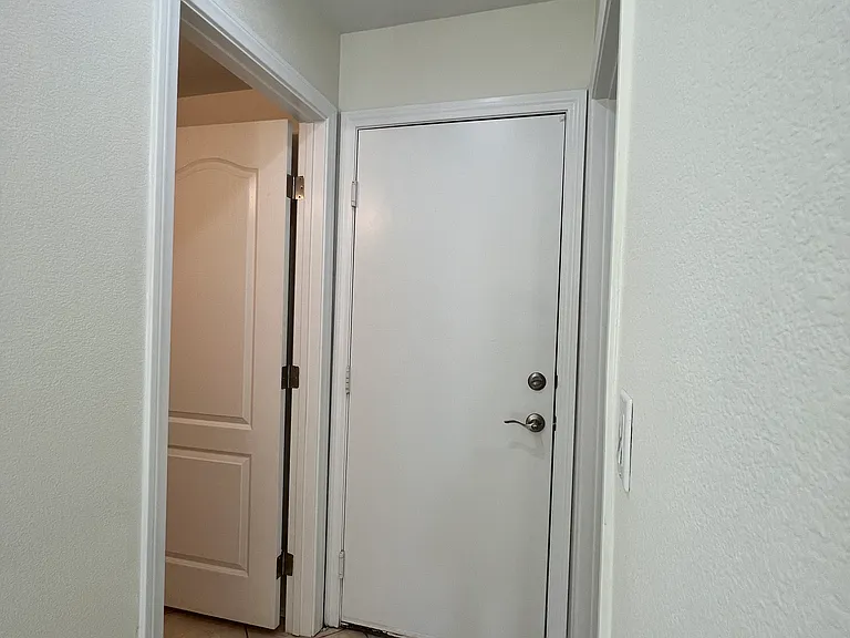 The downstairs hallway leads to the Garage (front), 1/2 bath (left), and Laundry Room (right).