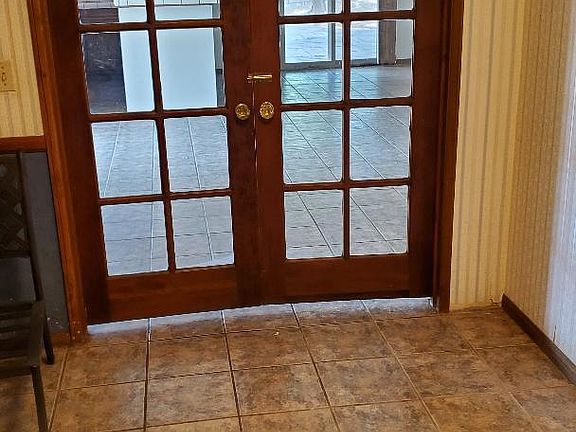 Glass doors to large family room with bar.