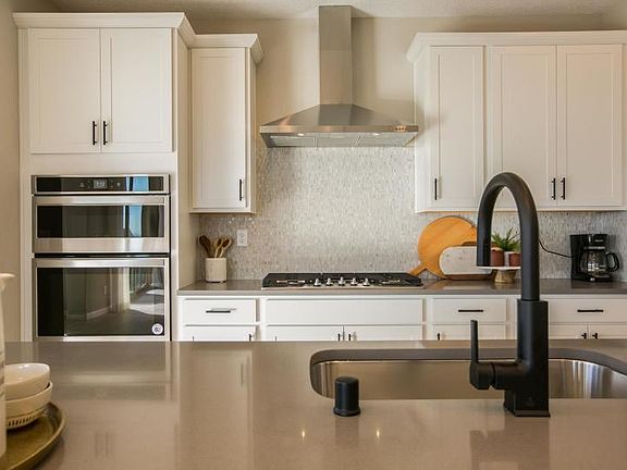 Use the kitchen island as a casual spot for busy morning breakfasts or to host your cocktail party a