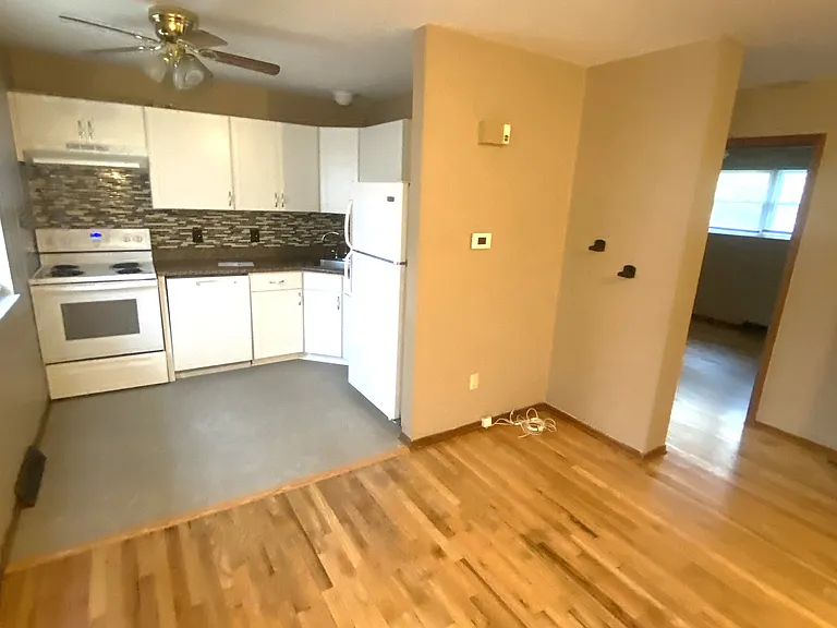 View of living room and kitchen with refurbished hardwood flooring!