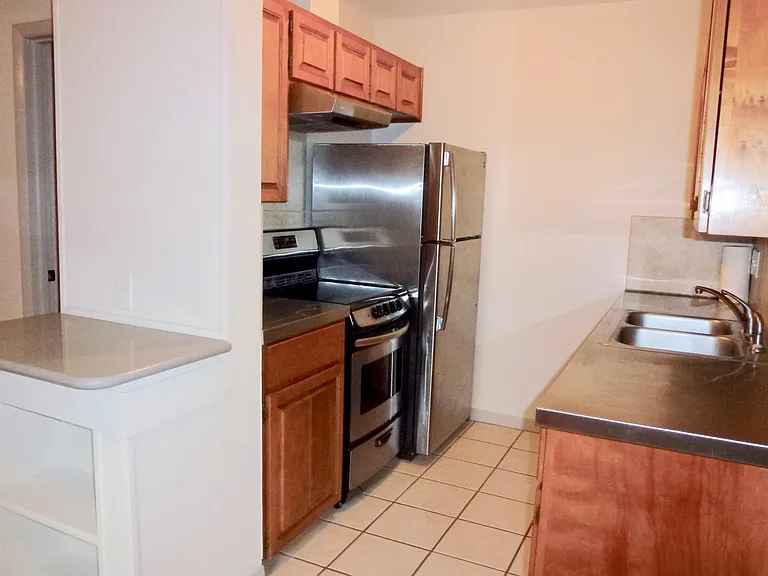 Stainless countertop, dishwasher, refrigerator.