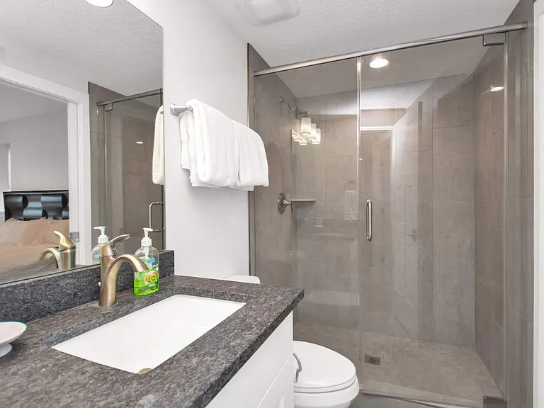 Full sized bathroom with large walk in shower