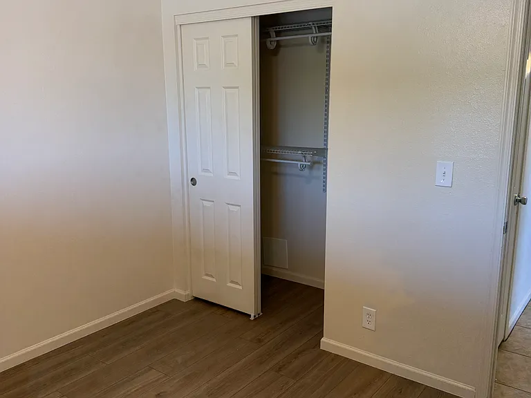 Bedroom #1 closet with new laminate floors
