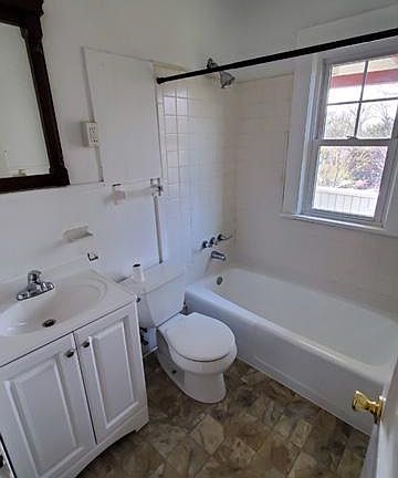 Updated bathroom with new floor and vanity, re-glazed tub.