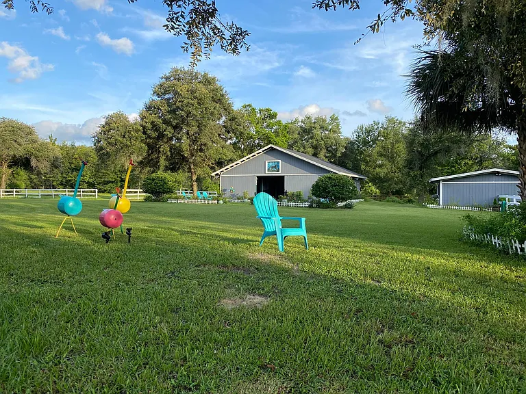 Lawn between house and barns. It is a short walk but not too close. The property has 7 acres of lawn...no kidding!