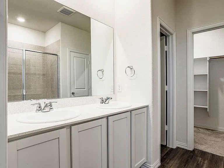 Bathroom with vanity, an enclosed shower, and hardwood / wood-style floors