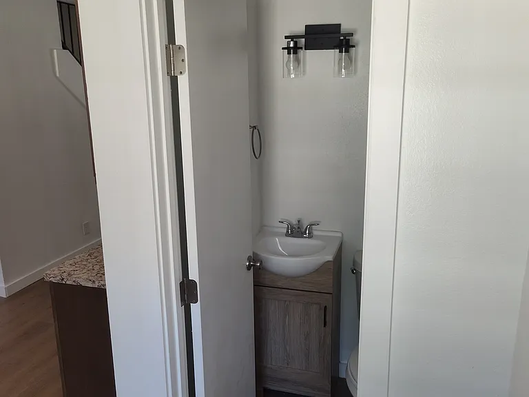 1/2 bathroom standing by the backdoor.