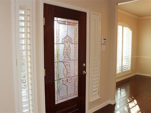 You will love welcoming guests through the impressive leaded glass door to a beautiful interior!