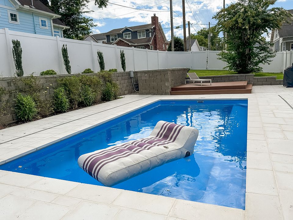 Enjoy a private backyard with a heated in-ground pool, sun deck, and Firerock pavers. Thoughtful landscaping creates a relaxing outdoor space perfect for evening unwinding or weekend entertaining.