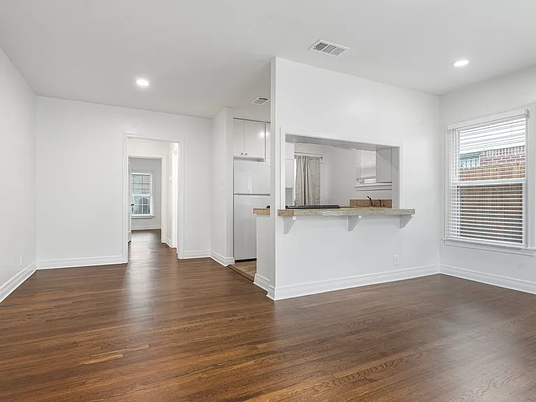 From Living Room, Walk Through Hall With Stacked Washer/Dryer In Closet To Bedroom At Back Of House.