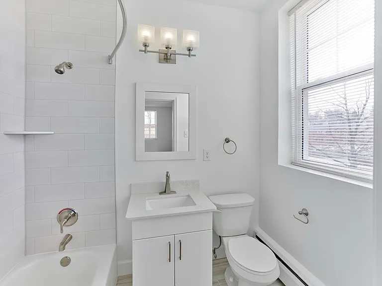 Bright and modern bathroom with updated fixtures and sleek tilework at Crestwood Apartments in Wayne, PA