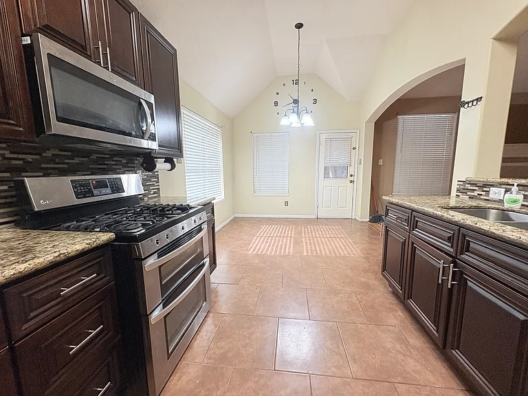 Kitchen w/ stainless steel microwave and range