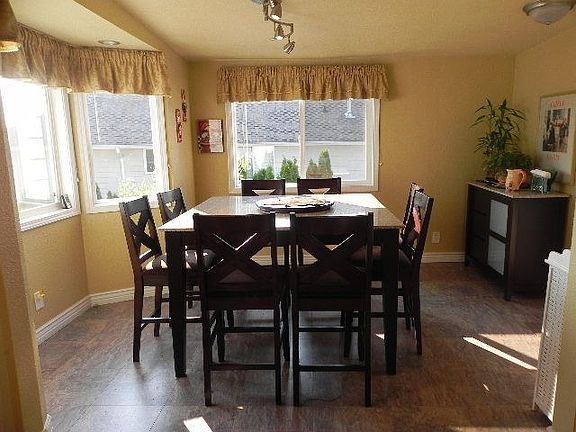 The light and bright informal eating area off of the kitchen provides access to the deck.