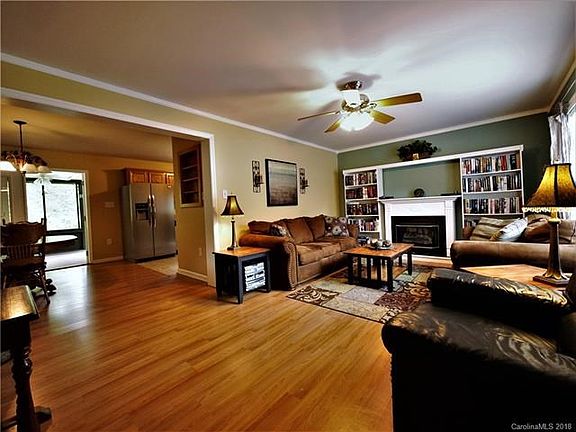 Living/Dining/Kitchen Opens to Enclosed Deck with View of Pond