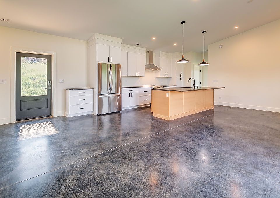 Entry into kitchen and light filled spacious living and dining area.