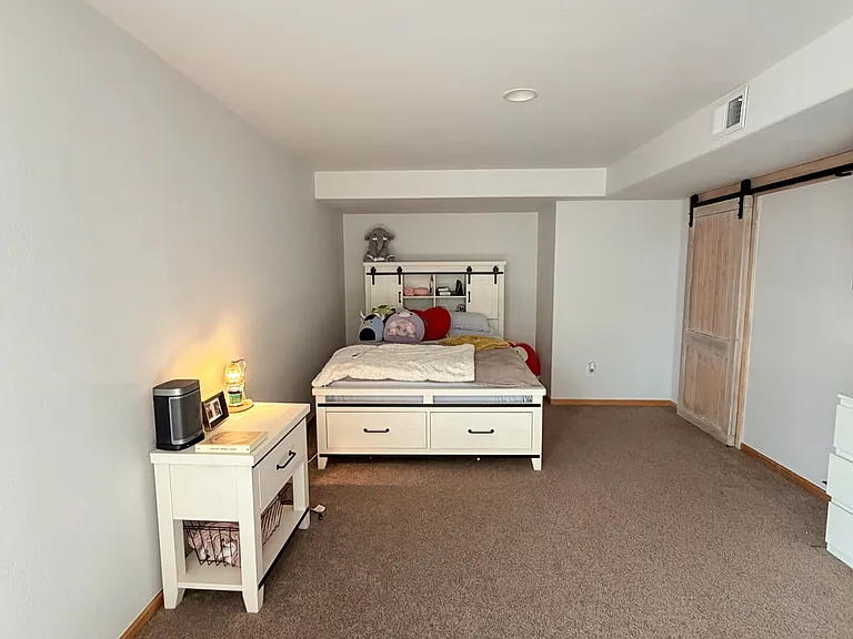 Bedroom #4, long and spacious bedroom with 2 sliding barn doors (one for entry way, one for walk-in closet) Tall ceilings. Fresh paint