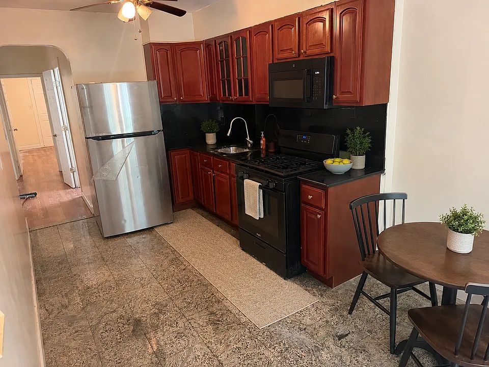Virtually staged kitchen and dining area. Furniture and decor were digitally added for visualization; the apartment's permanent features and layout are unchanged.