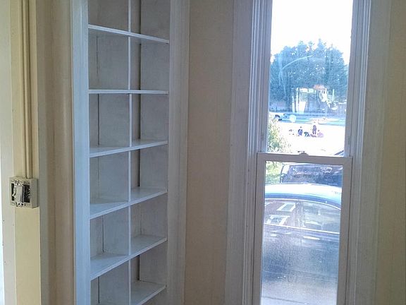 Living Room Built in Bookcases. Looking out front windows to community garden