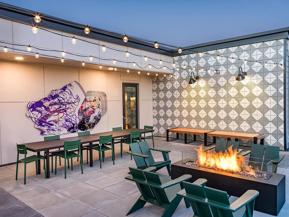 Unwind under the stars at Modera Woodstock's outdoor terrace, featuring a warm and inviting firetable.
