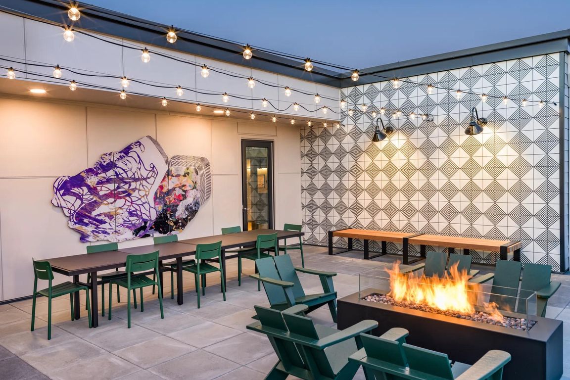 Unwind under the stars at Modera Woodstock's outdoor terrace, featuring a warm and inviting firetable.